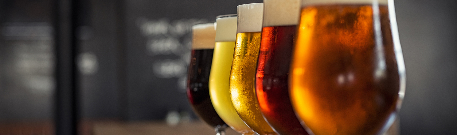 rows of colorful beers in glasses