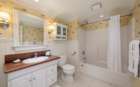 private bedroom toilet with white and yellow accents 