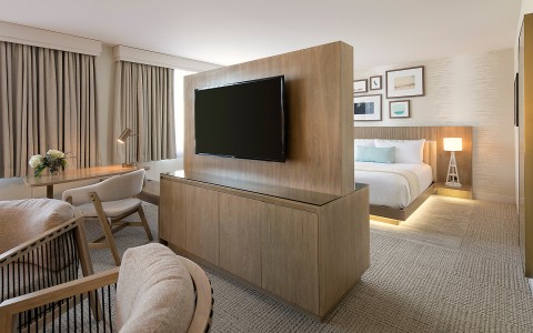 side of a suite with a desk and flat screen