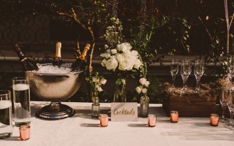 cocktail table with champagne bottles in an ice bucket