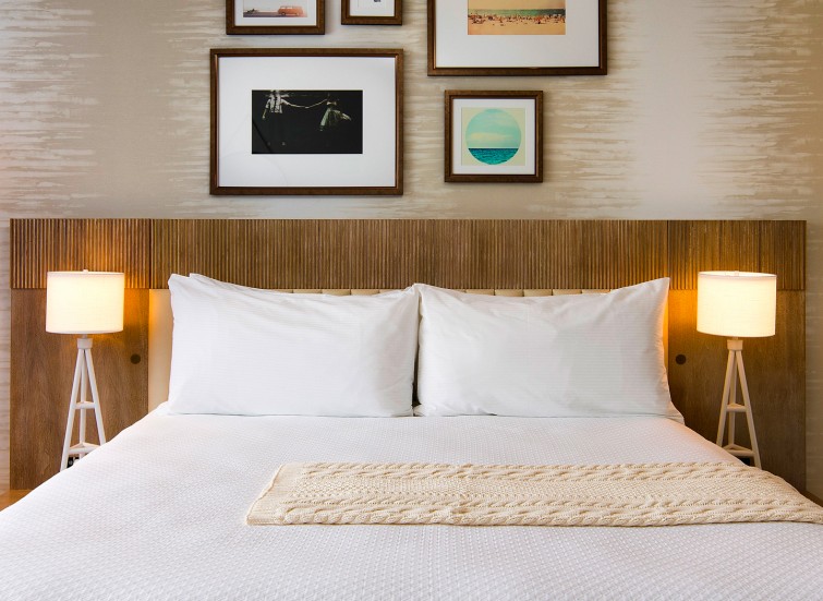 bed with collage of frames as headboard