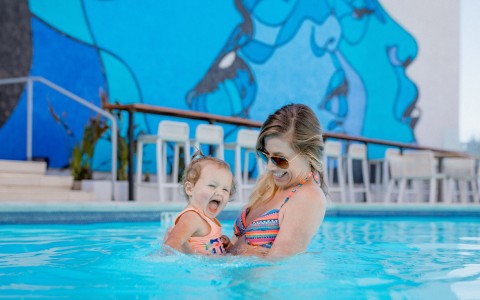 Woman and baby wading in a pool