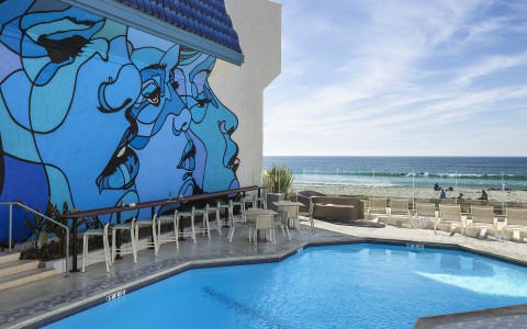 View of pool, ocean and blue mural 