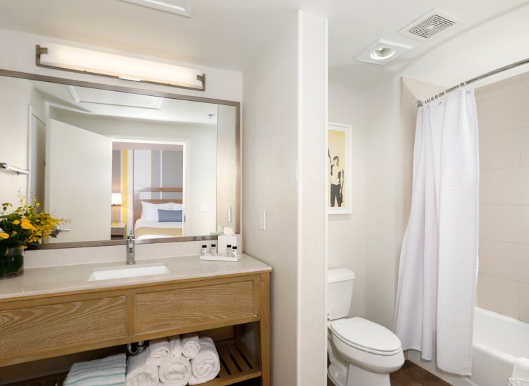 Hotel bathroom with vanity, toilet and shower
