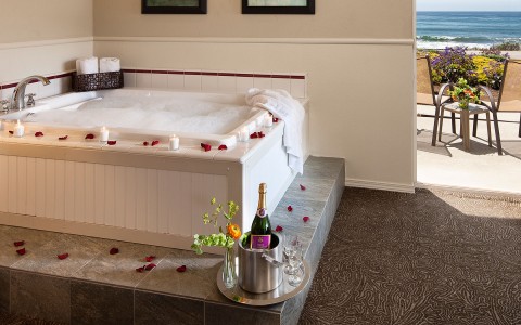 Hot tub lined with rose petals and champagne