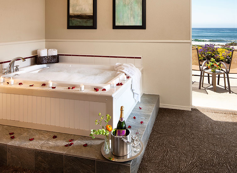 hot tub lined with rose petals and champagne bottle