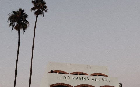Lido marina Village main entrance during the evening and a parked car 