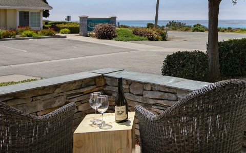 Partial ocean view patio with 2 chairs