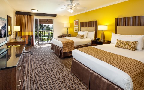 double beds in a hotel room with large balcony