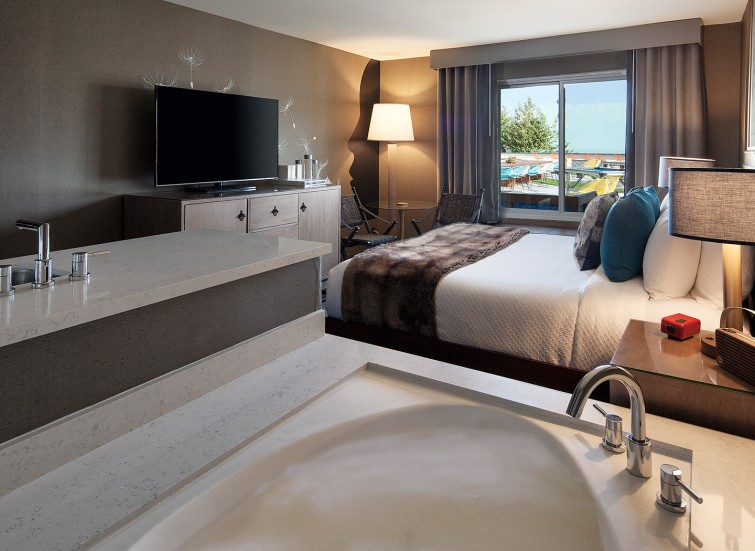 hotel bedroom with one bed and a hot tub