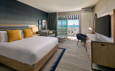 a guest suite with king bed and ocean views