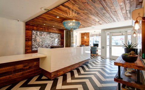 hotel lobby with black and white striped floor and blue chandelier