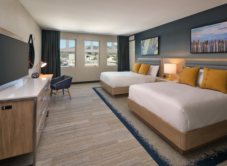 a guest suite with a2 beds with beach inspired decor