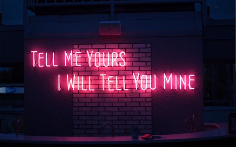 neon sign that says tell me yours and i will tell you mine