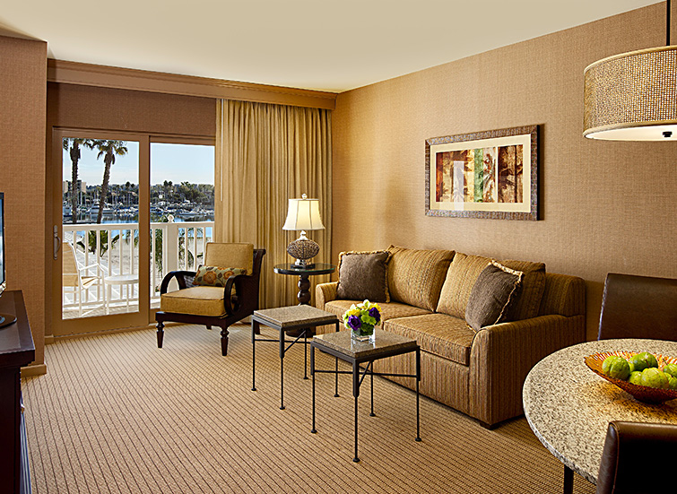 living room in the hotel with sliding glass door with a view of marina