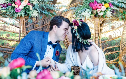 bride with flower crown kissing her groom