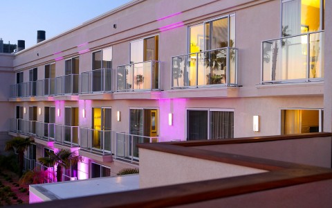 exterior of hotel side being lit up by purple lights