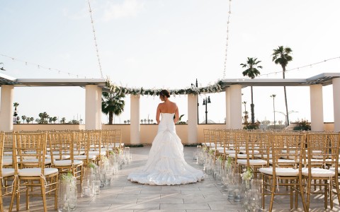 bride posing in front of an altar at sun set