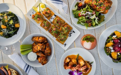 variety of restaurant dishes including spicy chicken wings and beet salad