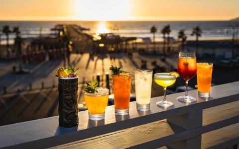 seven summer cocktails on pier overlooking ocean views