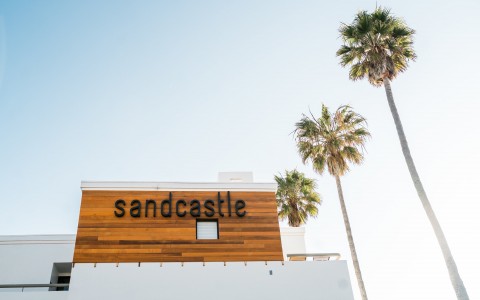 sandcastle hotel on the beach sign