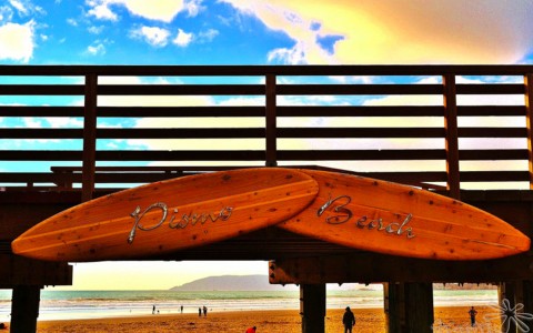 Pismo Beach pier decorated with surfboards