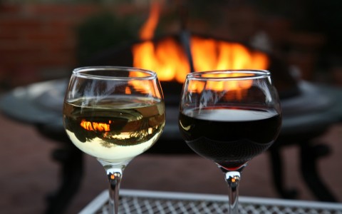 Glasses of wine in front of fire