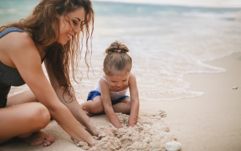 Mom and kid playing in sand