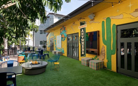 outside view of restaurant with yellow paint and cacti 