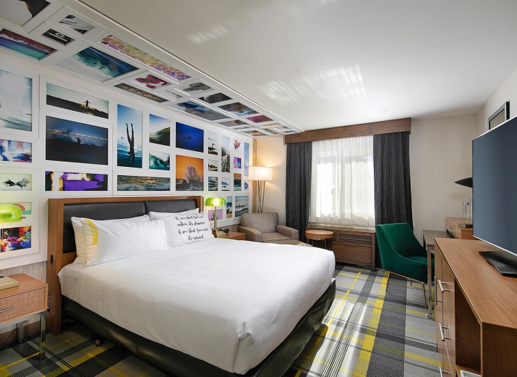 hotel king bed with gray yellow plaid carpet 