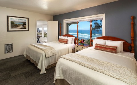 guest room with two queen beds and views of the ocean