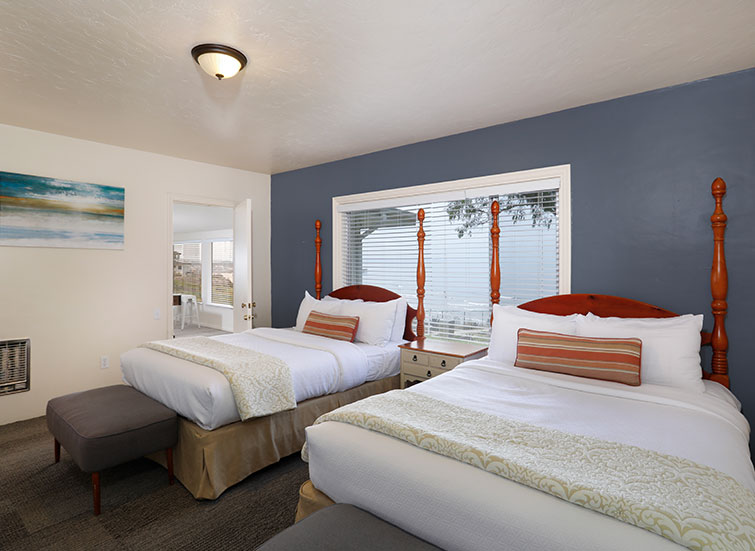 a guest suite with two queen beds