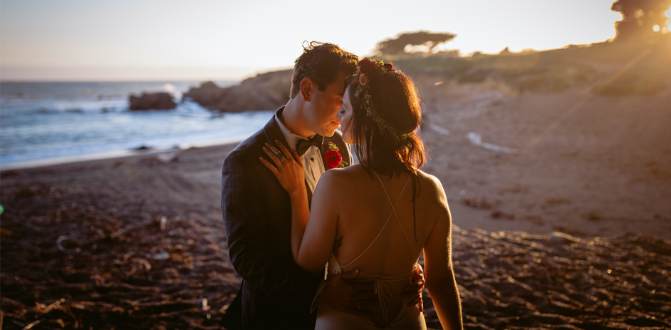 a couple dancing on the beach in formal wear