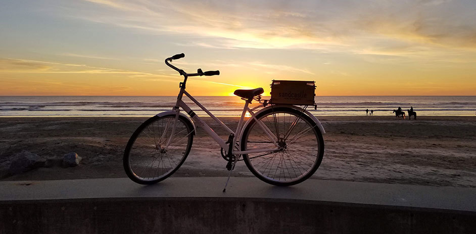 bike on the beach in the sunset