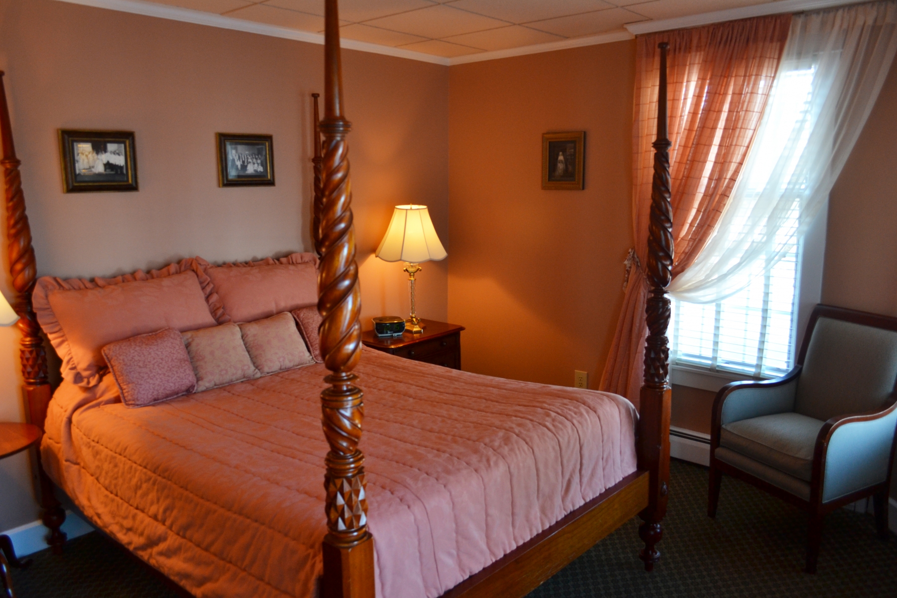 large hotel room with red bedding and curtains 