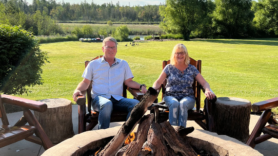 couple sitting in front of a fireplace