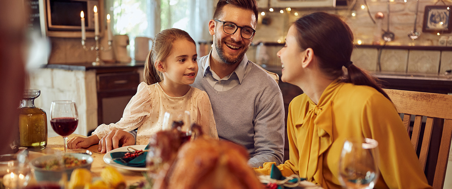 family smiling and dinning together