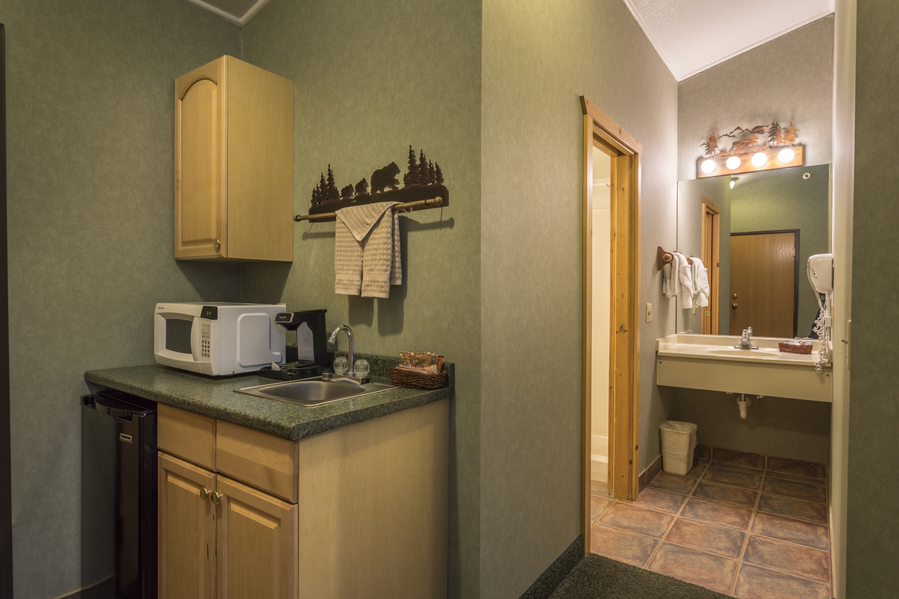 hotel room kitchenette with green walls and and bathroom in the past
