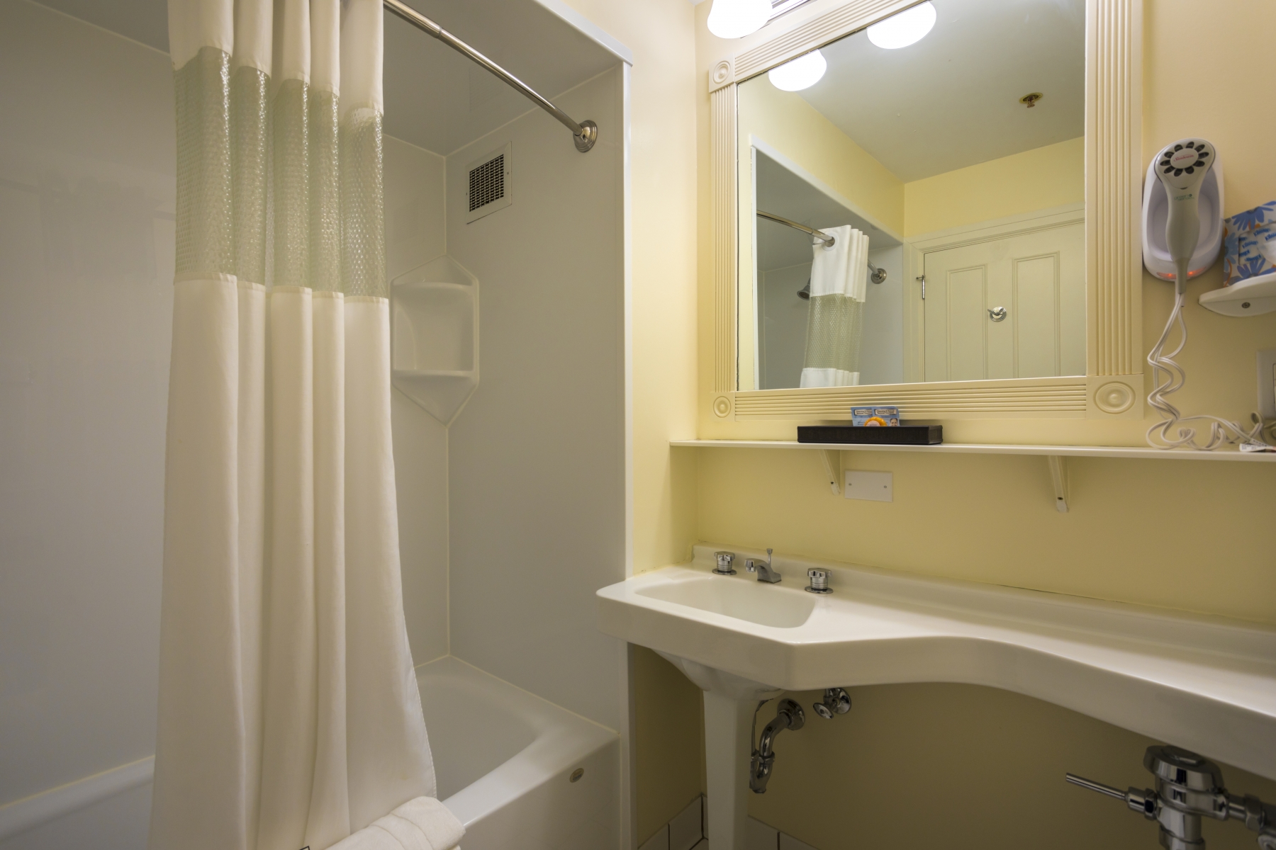 Inside bathroom, with tub, and white curtain 