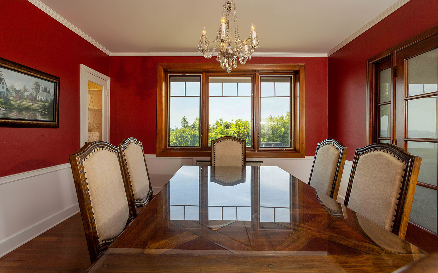 dinner room with a table and 5 chairs and red walls