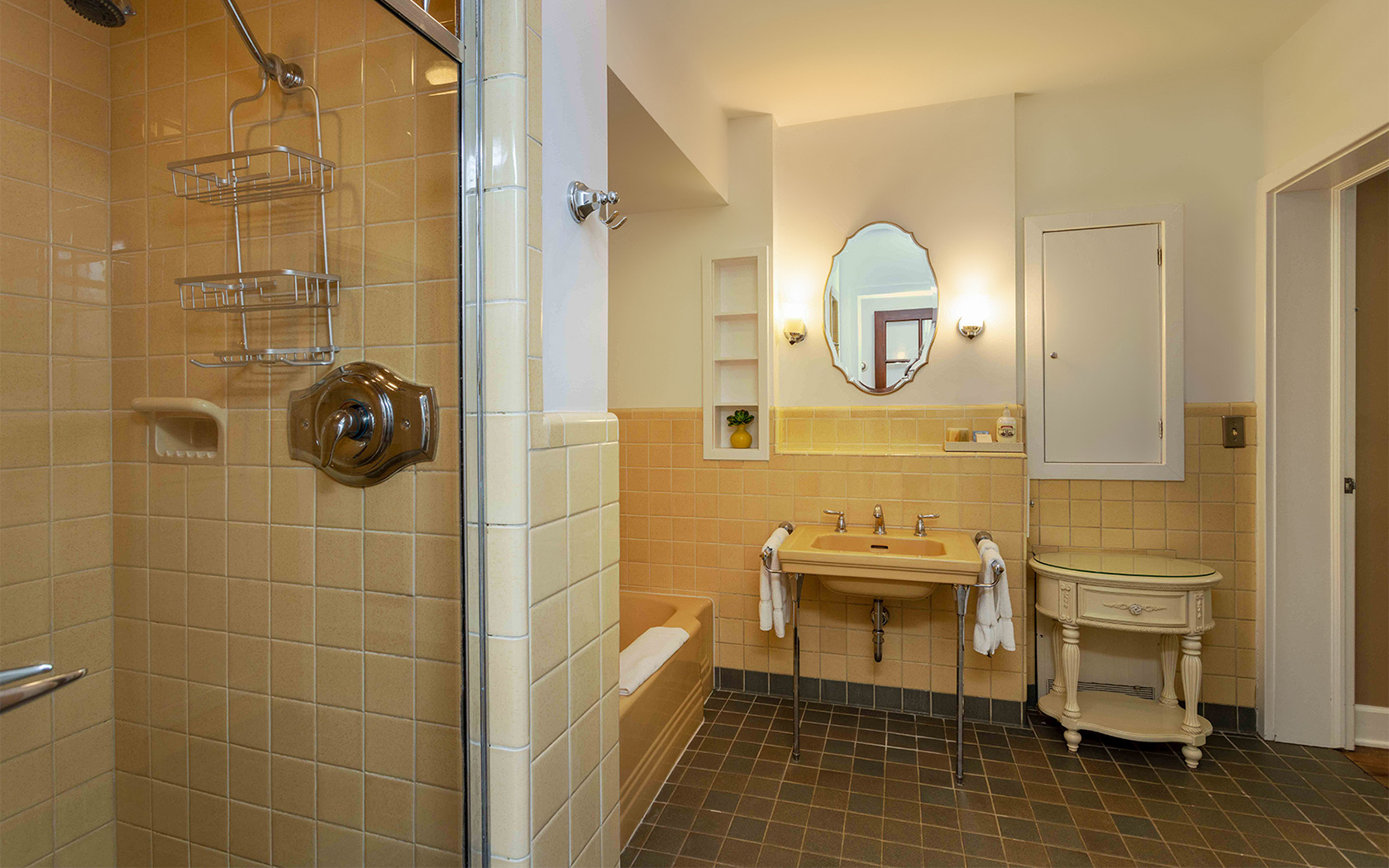 yellow bathroom with a shower and a tub 