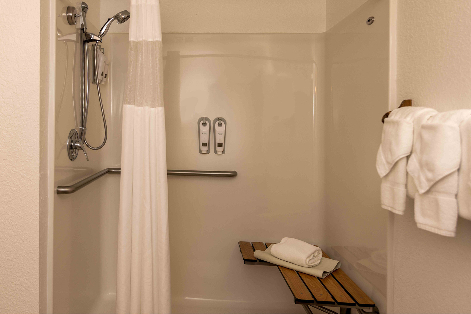 bathroom with a shower and two white towels
