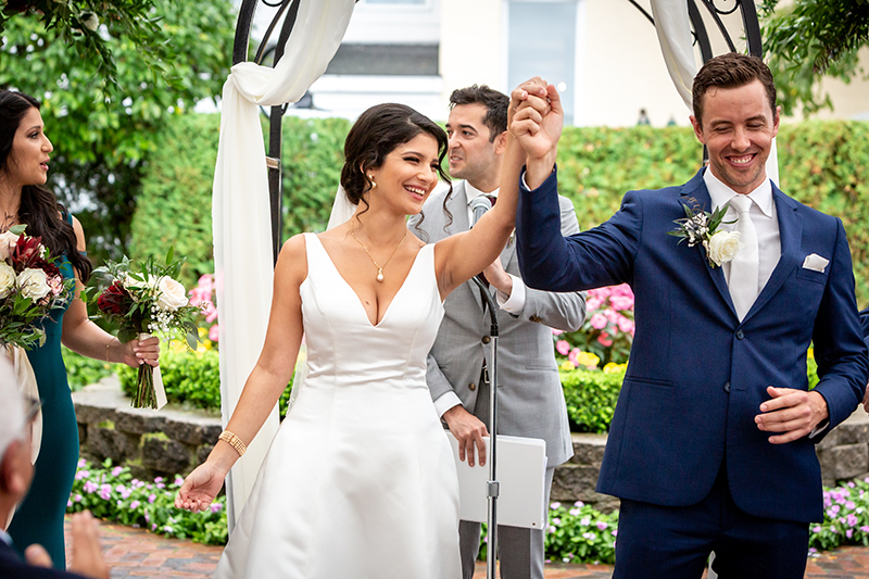 man raising up womans han and celebrating that they are finally married