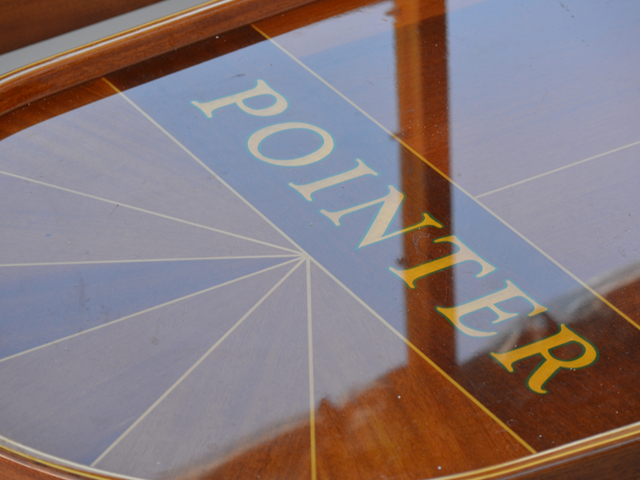 Wooden design with Pointer written in the middle of the design