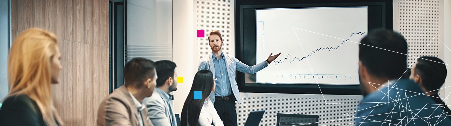 Business man presenting line graph in front of other colleagues
