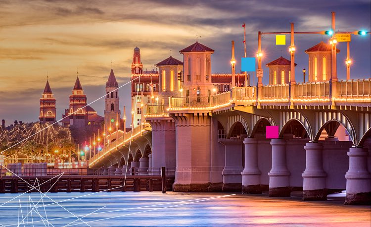 Antique building skyline by the water lit up at night