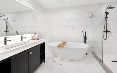 marble bathroom with tub and shower