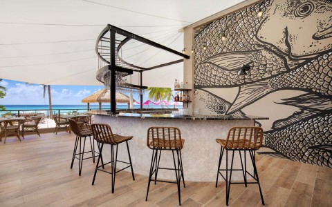 outside bar with chairs and fish wallpaper