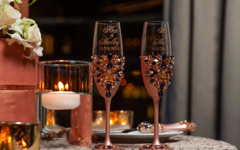 custom champagne wedding classes and candle floating in water