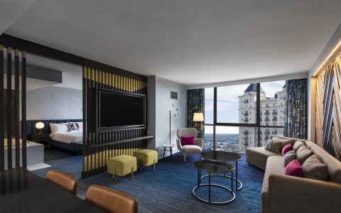 large suite with living room and city view windows